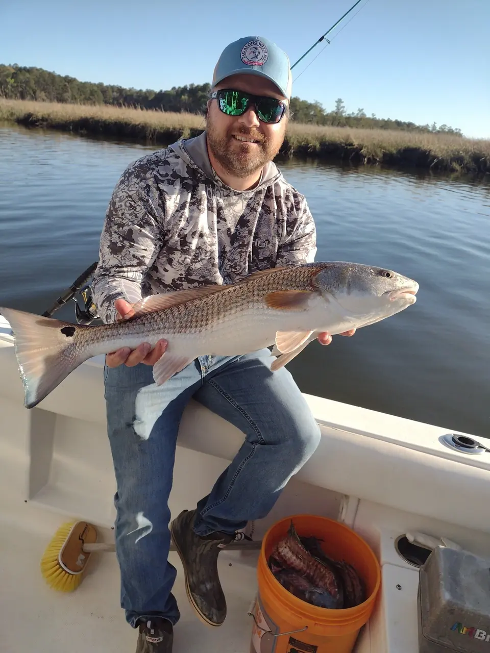 Angler holding a redfish caught on a Tampa Bay inshore fishing charter