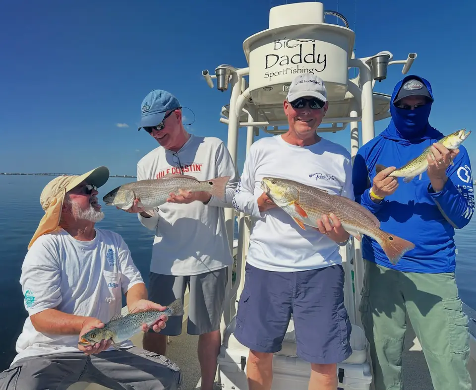 Group of anglers with their redfish and trout catch aboard the Big Daddy Sportfishing boat in Tampa Bay.