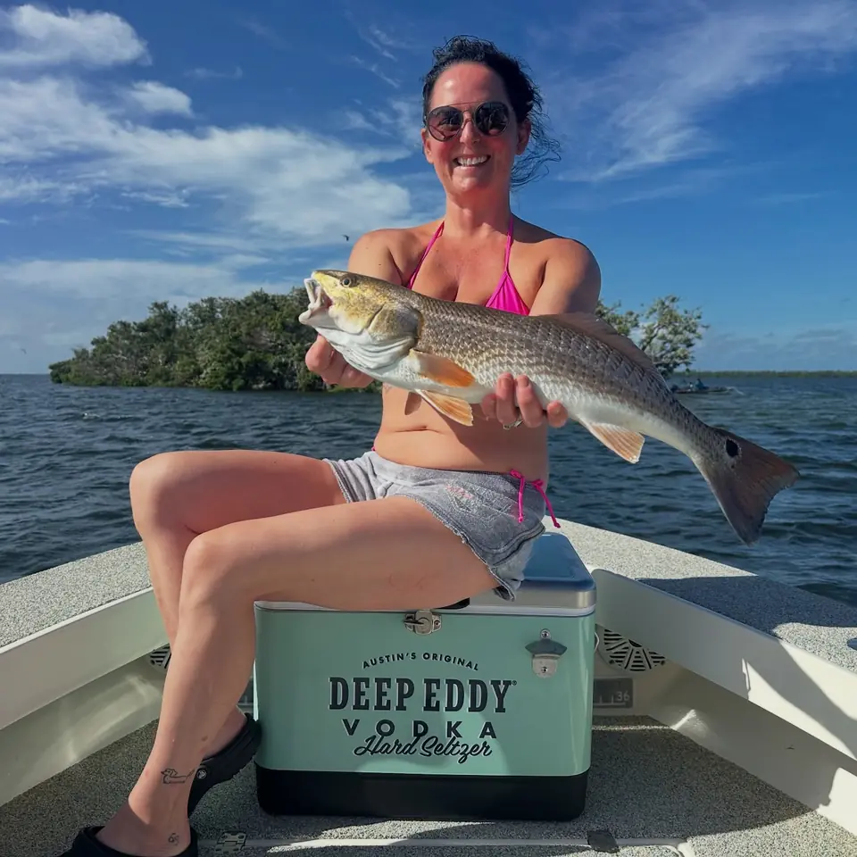 Woman holding a redfish caught on a Tampa Bay inshore fishing charter with Big Daddy Sportfishing.