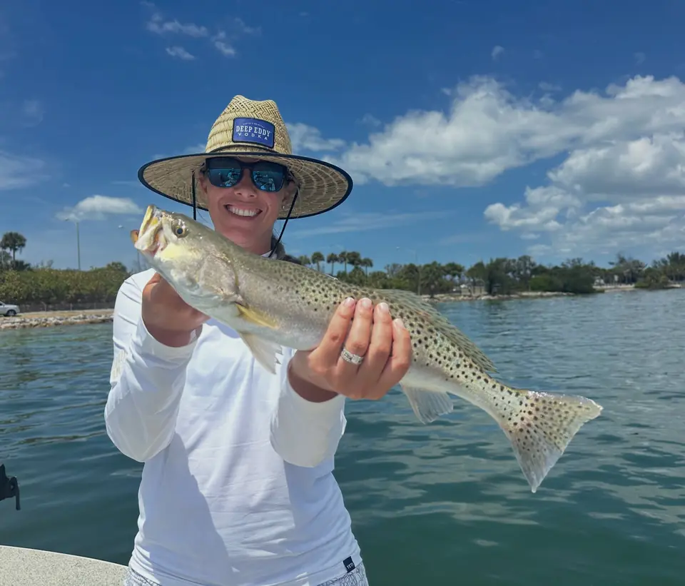Woman holding a spotted seatrout caught inshore in Tampa Bay with Big Daddy Sportfishing.